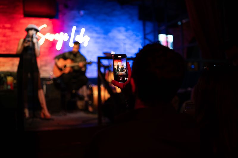 Live musical performance being recorded vertically with a smartphone
