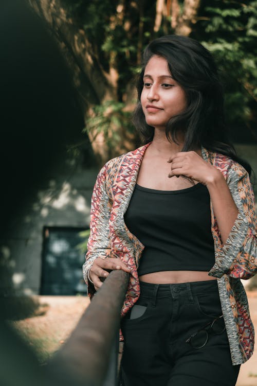 Young Woman in a Casual Outfit Standing Outside 