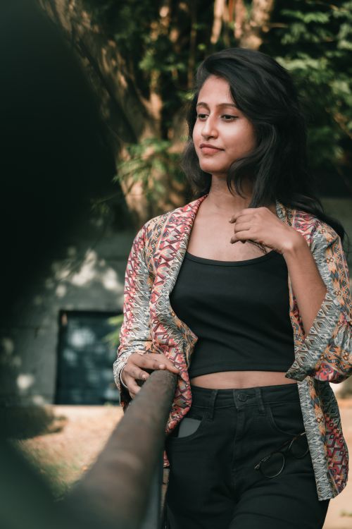 Free Portrait of a young woman standing outdoors in casual fashion during summer. Stock Photo