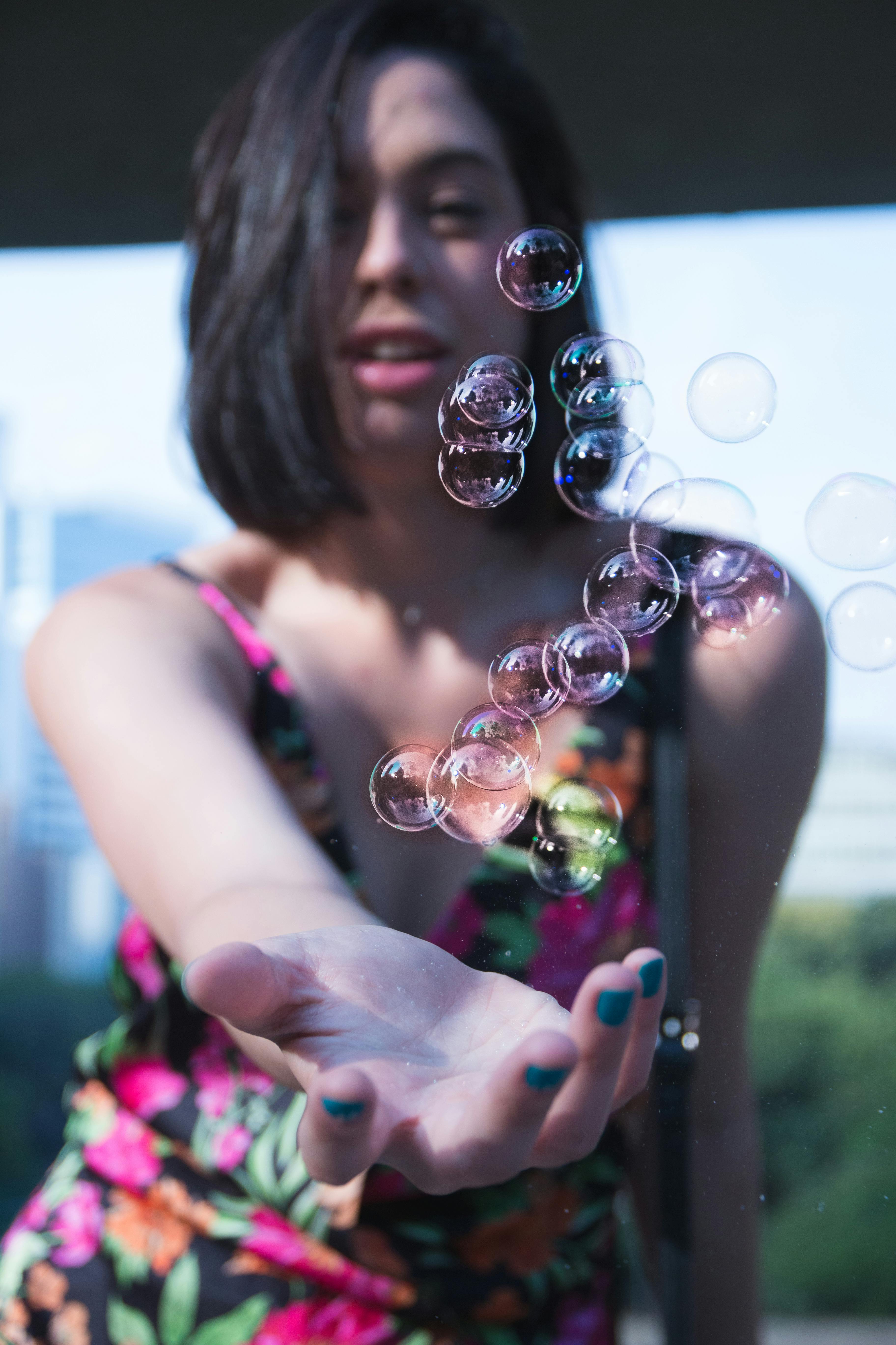 Selective Focus Photography Of Woman Reaching For Bubbles