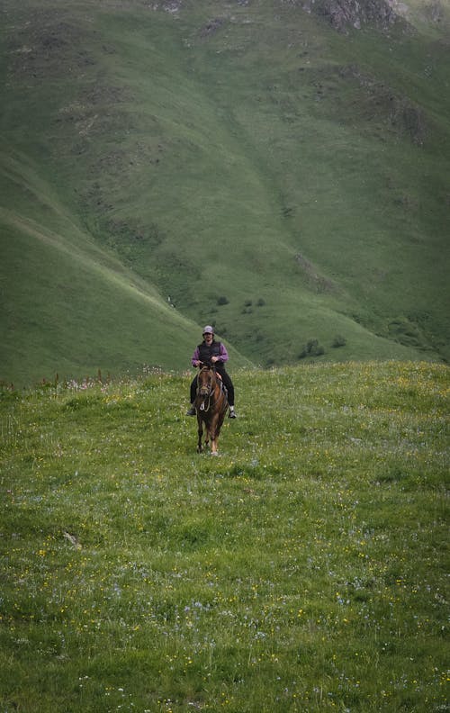 Man Riding a Horse in a Valley