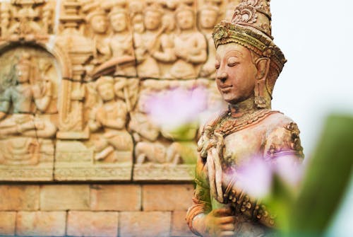 Close-up of a Sculpture with a Temple in the Background 