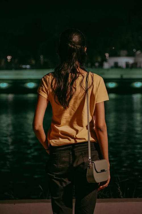 Back View of Woman in T-shirt and with Bag