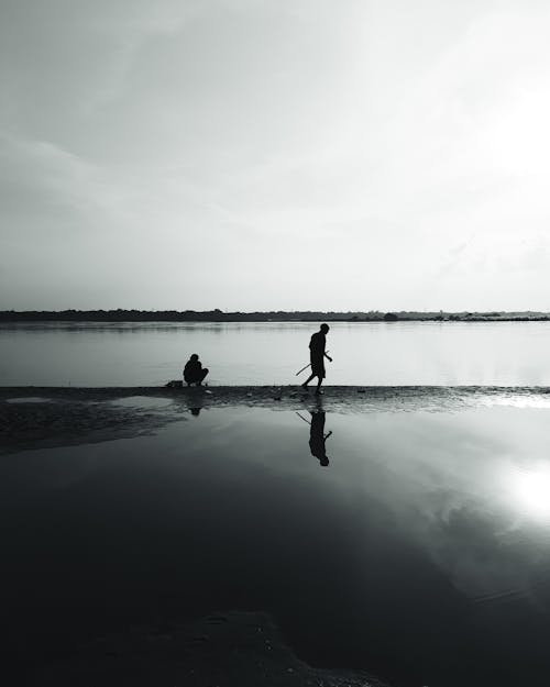Silhouettes of People on a Beach in Black and White 