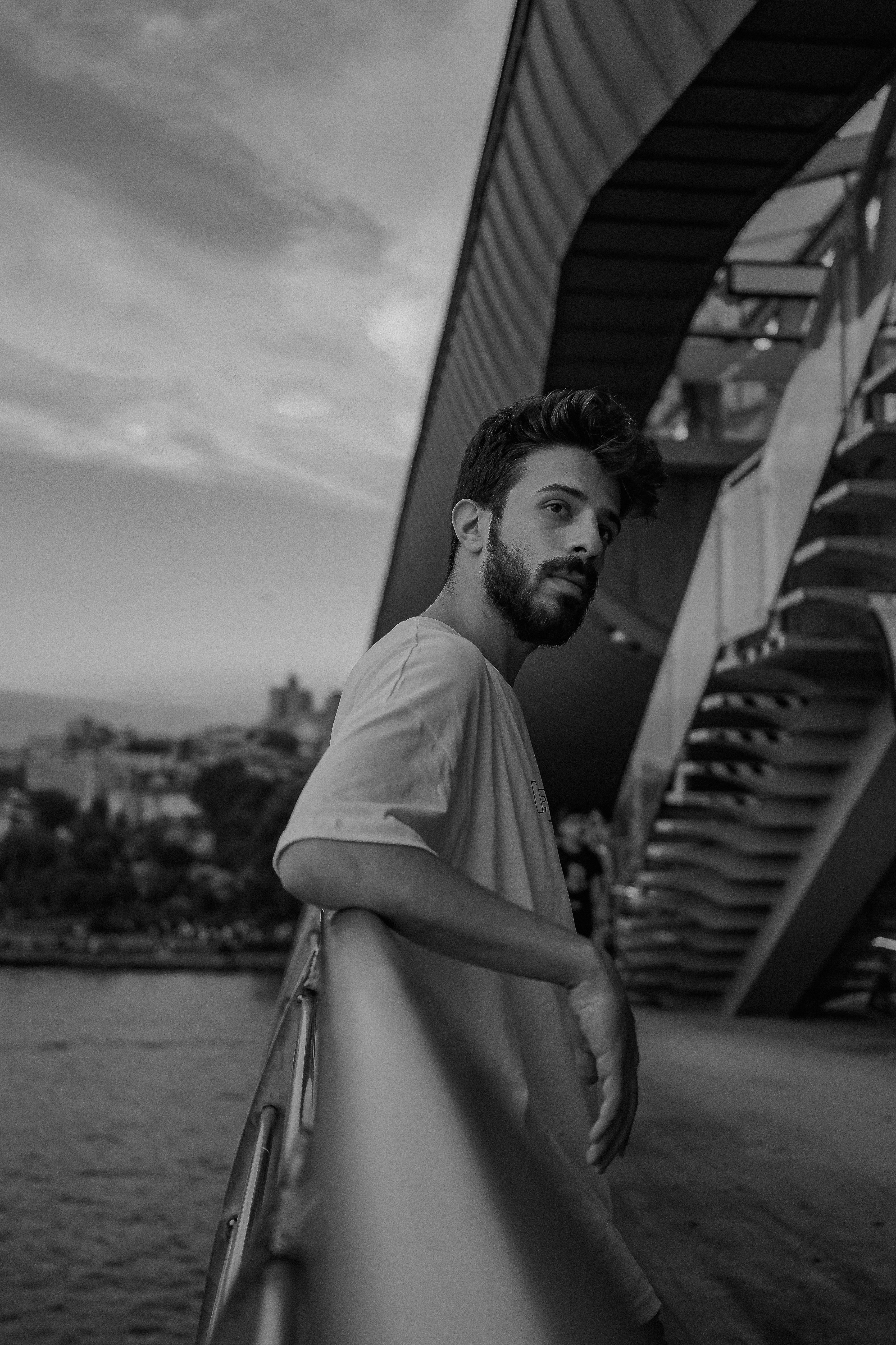 Man Standing by Railing on Bridge · Free Stock Photo
