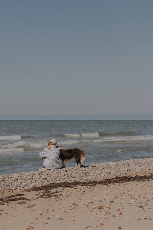 Woman with a Dog on a Beach
