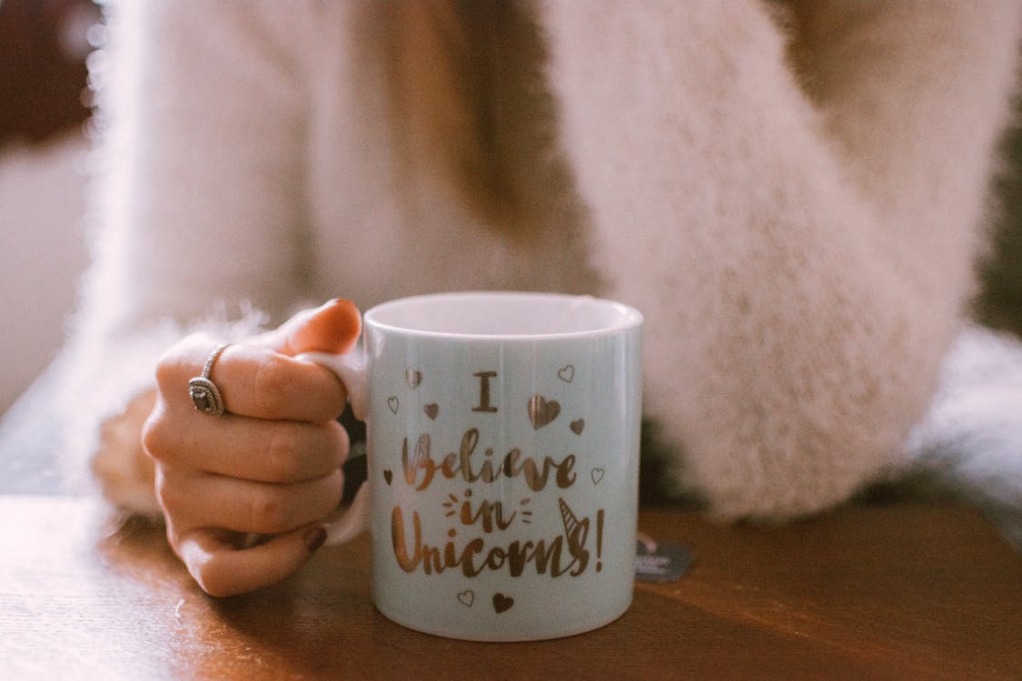 Free Selective Focus Photography Of Person Holding Mug Stock Photo