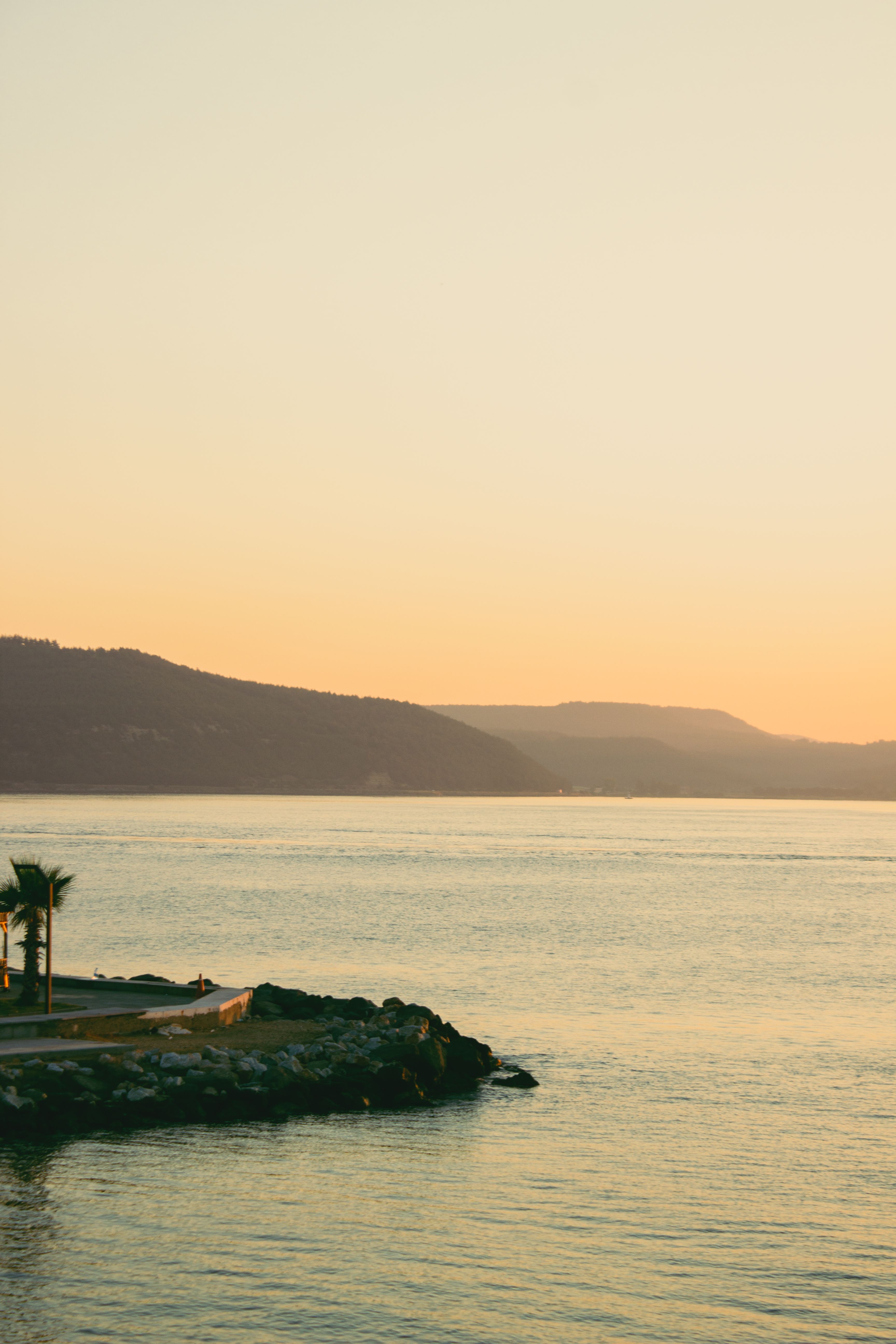 Clear Yellow Sky over Sea Shore at Sunset · Free Stock Photo
