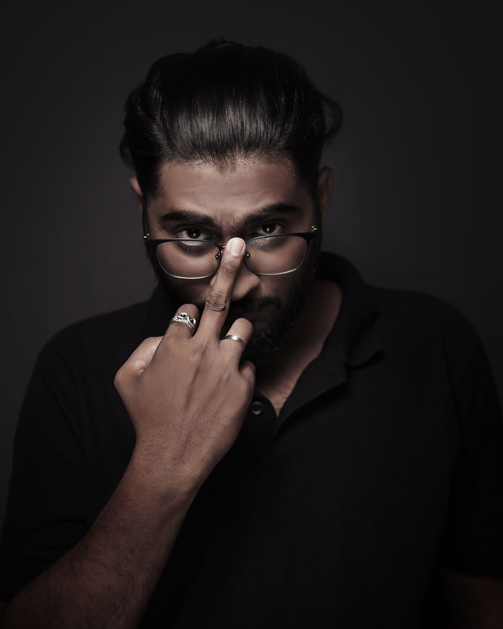 Man adjusting his eyeglasses