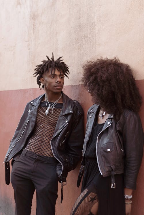 Man and Woman in Leather Jackets Standing and Looking at Each Other 