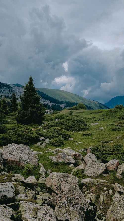 Free Breathtaking view of lush hills and dramatic clouds in Almaty, Kazakhstan's natural landscape. Stock Photo