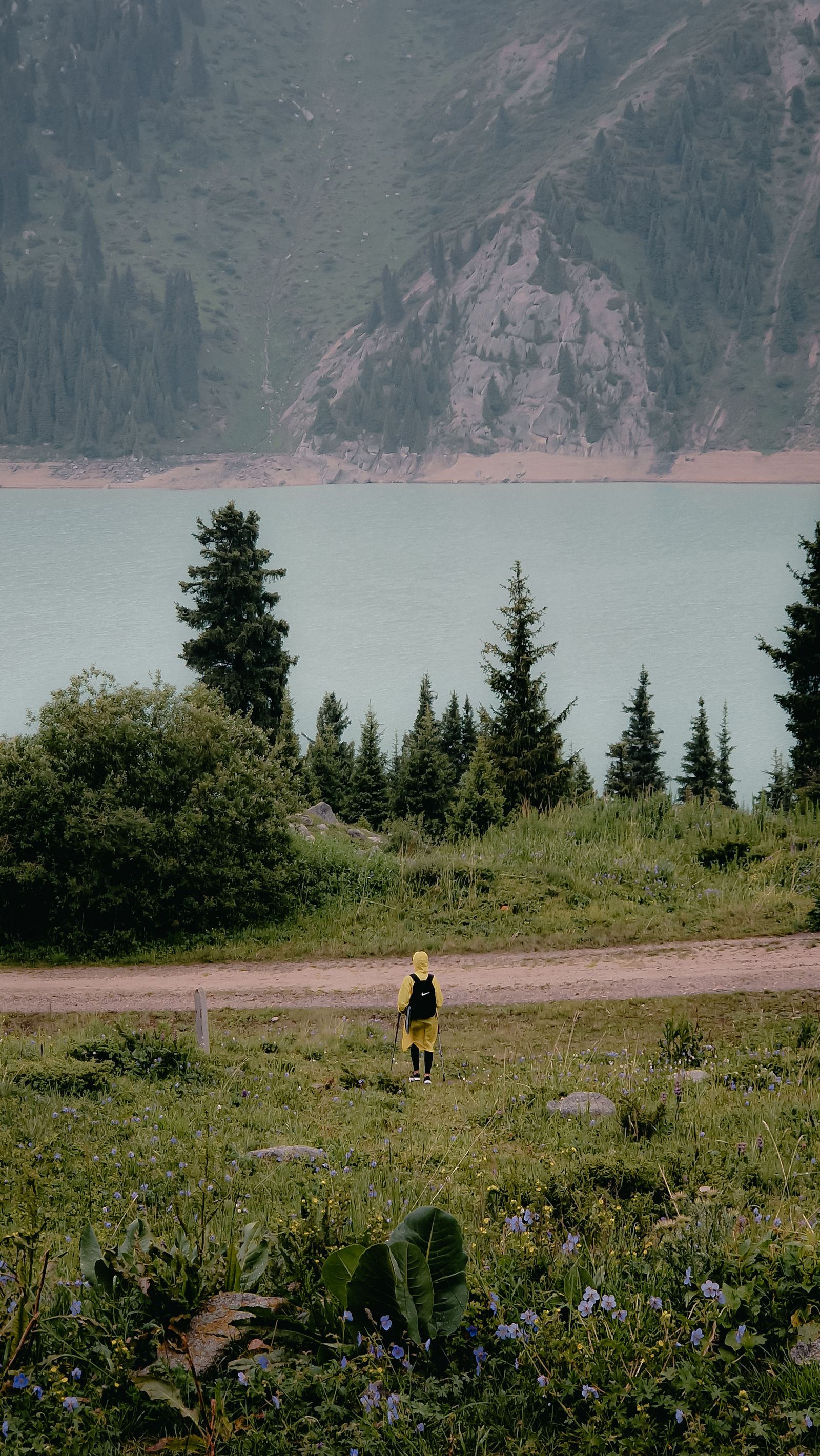 Traveller beside a mountain lake near Almaty