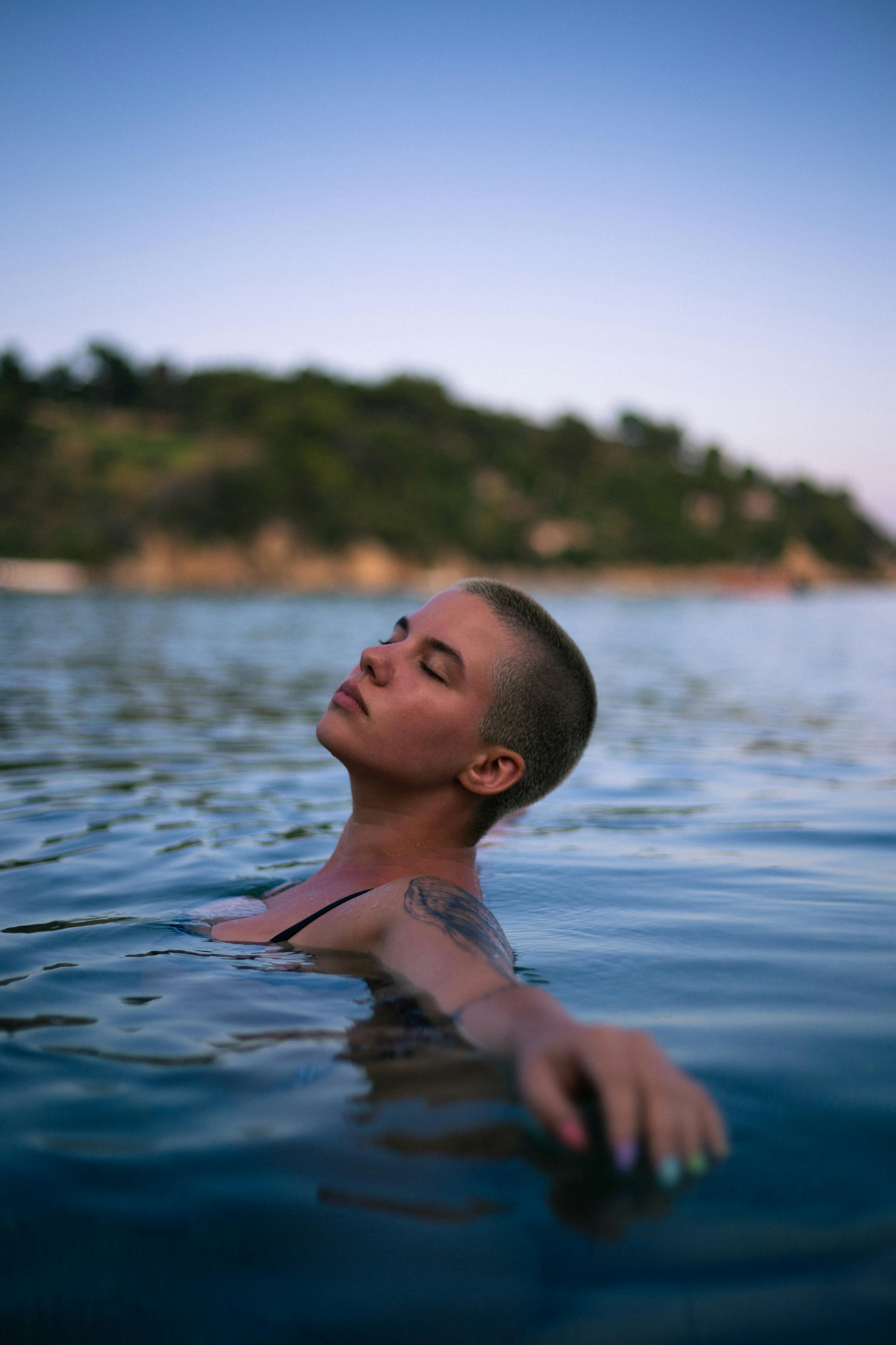 Bald Woman Swimming in Sea · Free Stock Photo