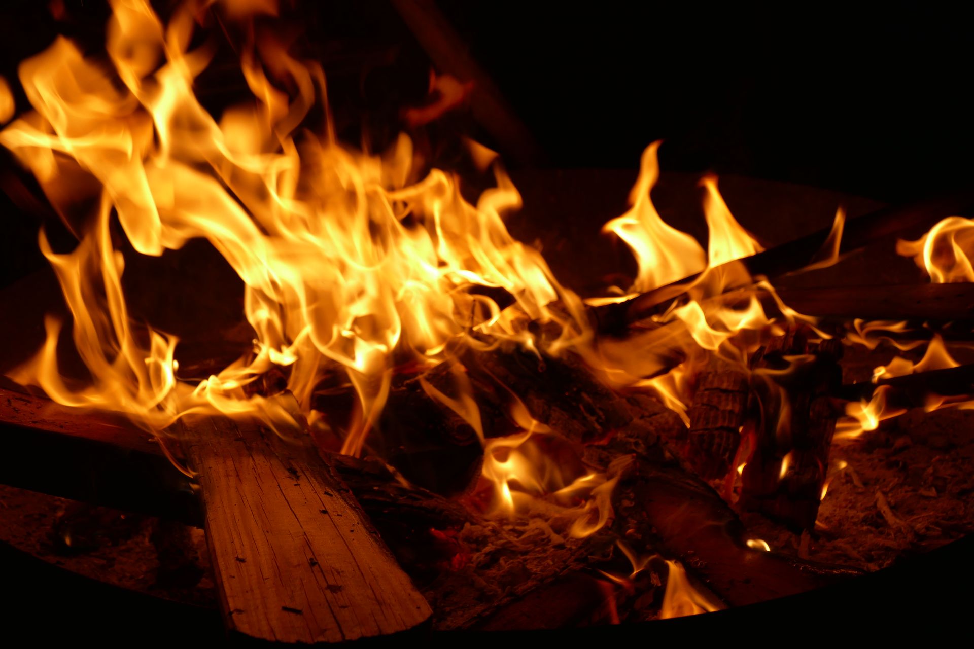 A warm and dynamic shot capturing the lively flames in a cozy fireplace setting.