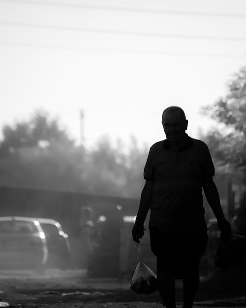 Silhouette of an Elderly Man on a Street in Black and White