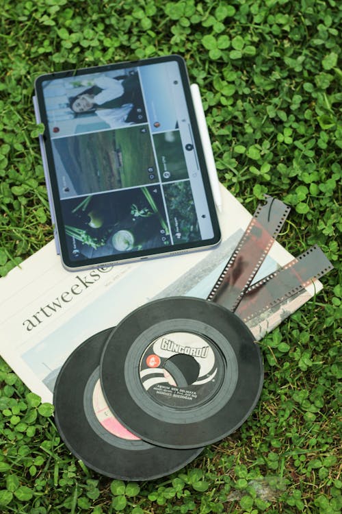 A Tablet and Film Rolls on the Ground 