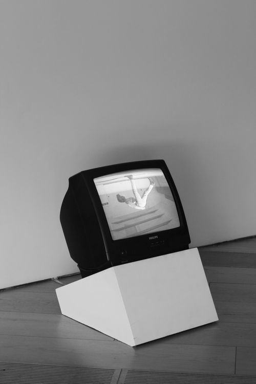 Free Black and white display of vintage TV in a minimalist art gallery setup. Stock Photo