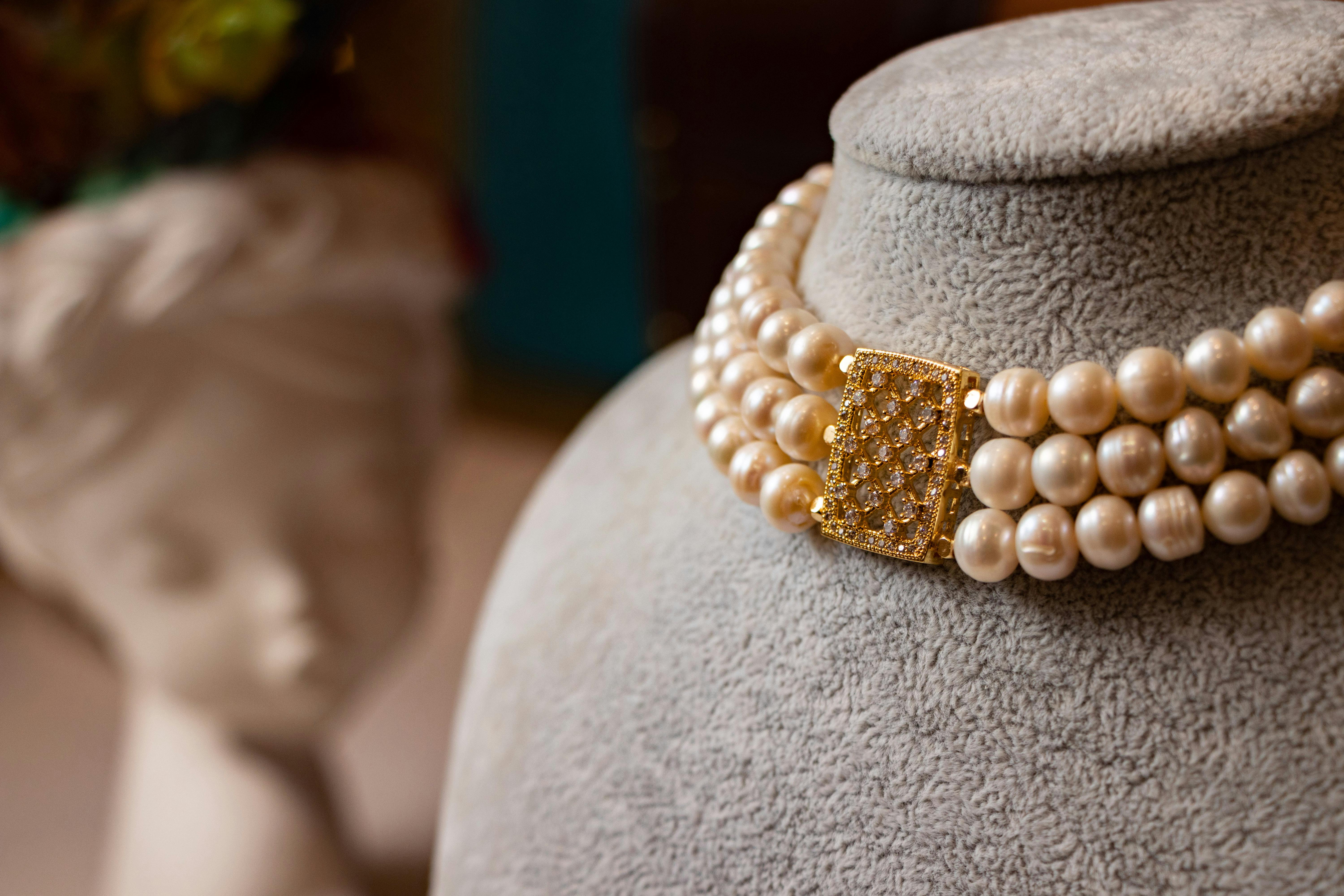 golden South Sea pearl necklace on a display bust - luxury pearl jewelry