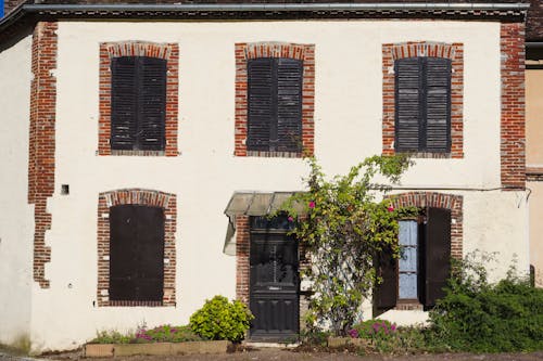 Facade of an Old Building with Wooden Shutters 