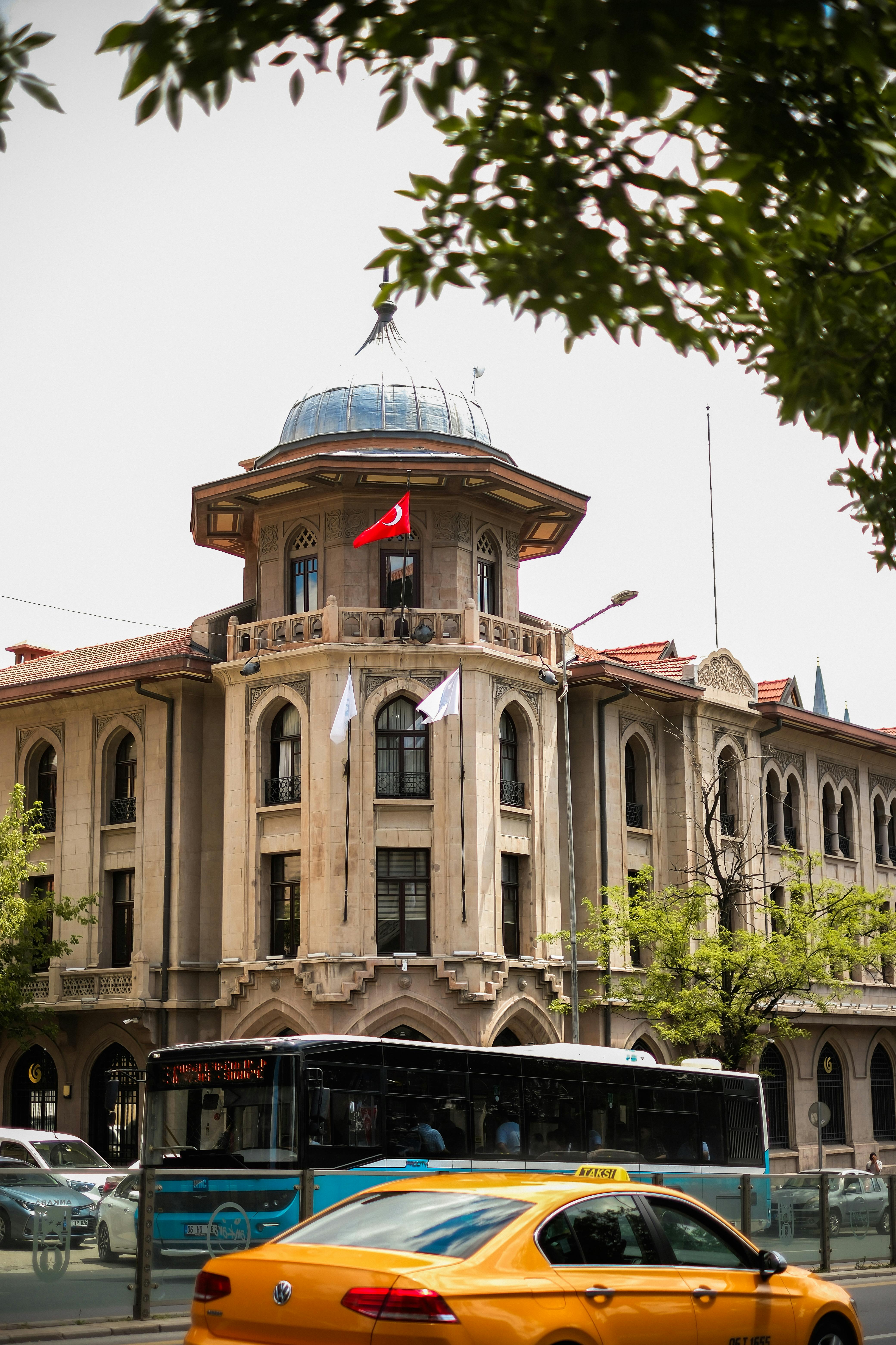 Classic architecture building in Ankara with public transport and traffic in view.