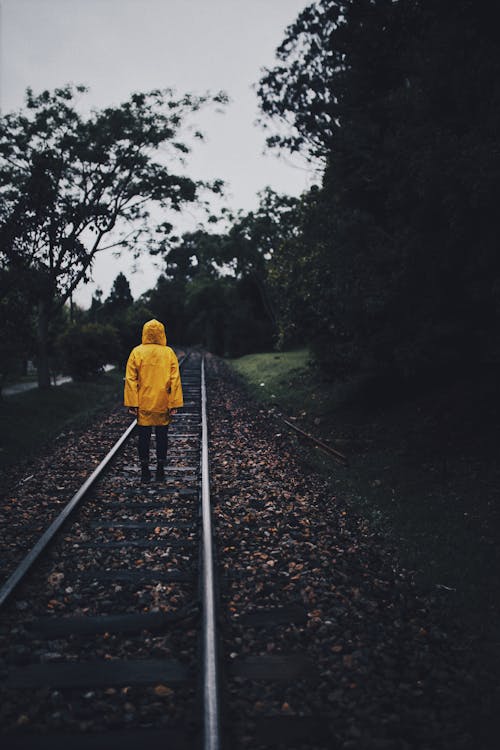 Person Standing on Train Rail