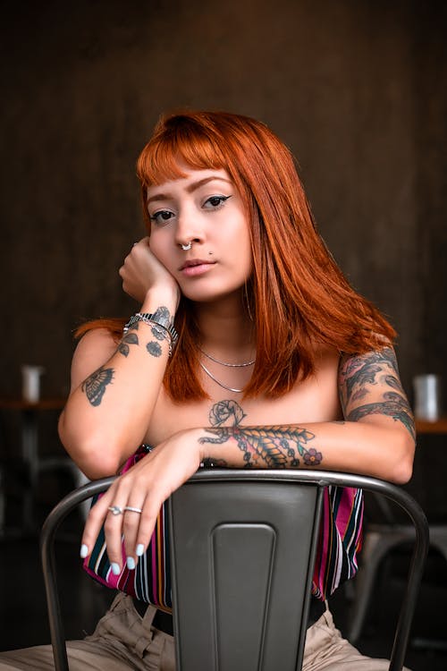 Woman Sitting on Gray Metal Chair