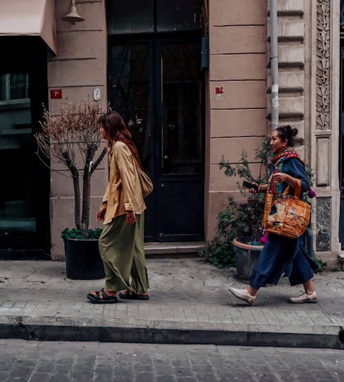 Women Walking near Building Wall in Town in Turkey