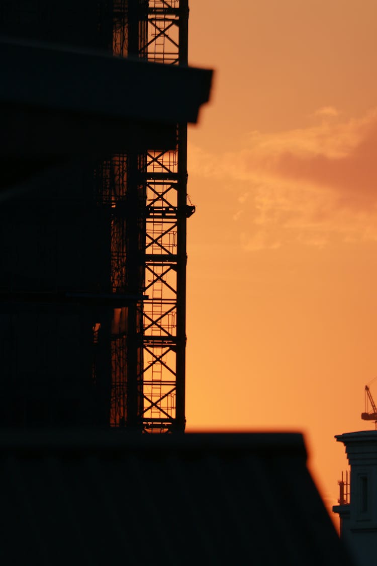 Yellow, Sunset Sky Behind Building Silhouette