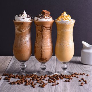 Three blended iced coffees topped with cream, photo by Diego Romero on Pexels
