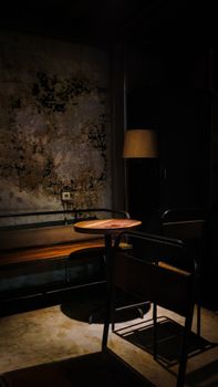 A dimly lit rustic interior corner featuring a wooden bench and table in Bandung, Indonesia.