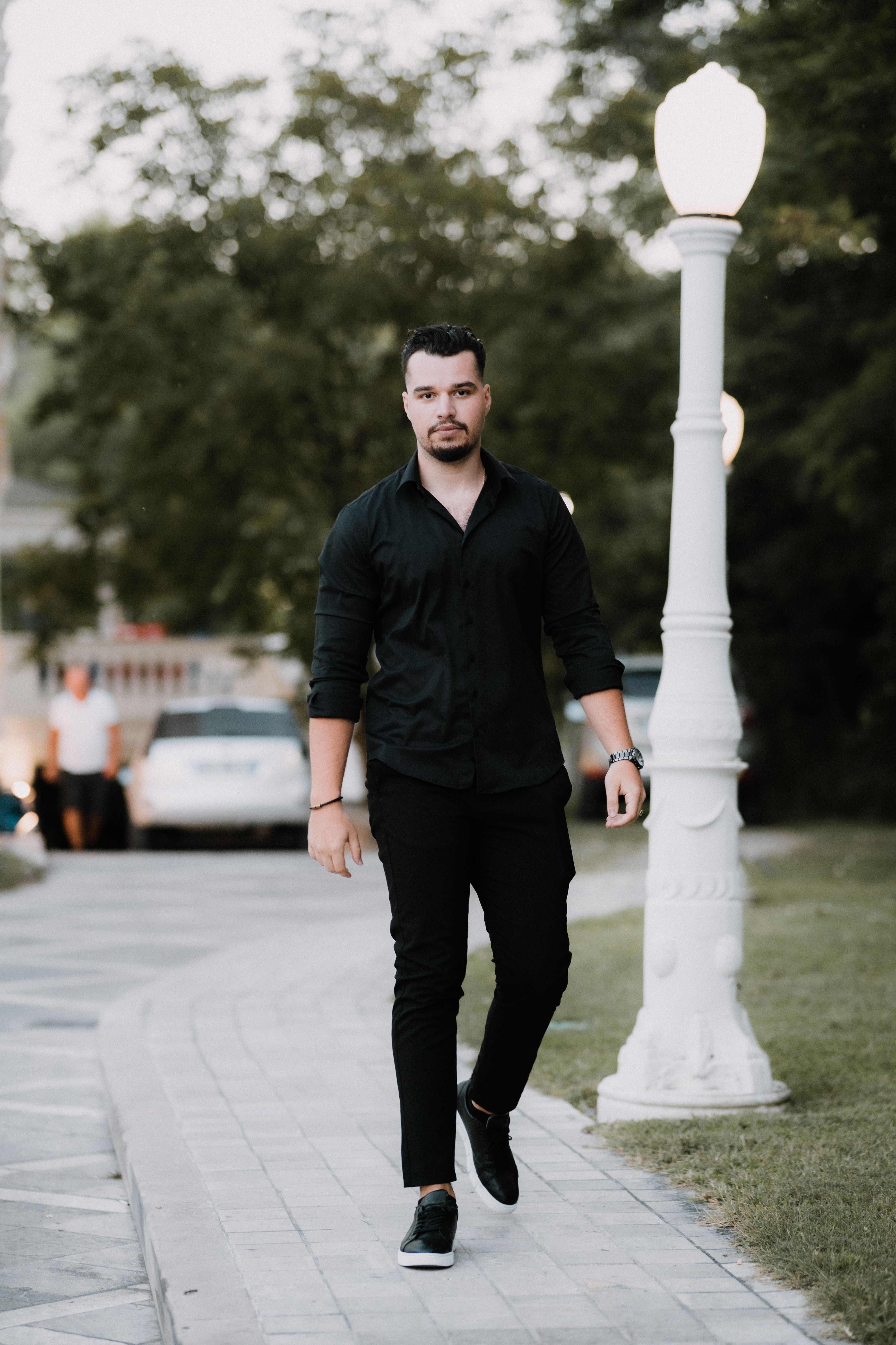 a man dressed in all black is walking Rich Black Leather Suit – StudioSuits