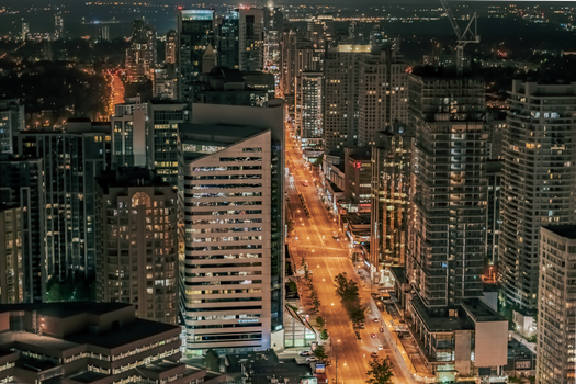 Stunning aerial view of Toronto's illuminated cityscape at night showcasing urban architecture.