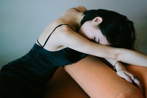 Free Woman in Black Dress Leaning on Couch Stock Photo