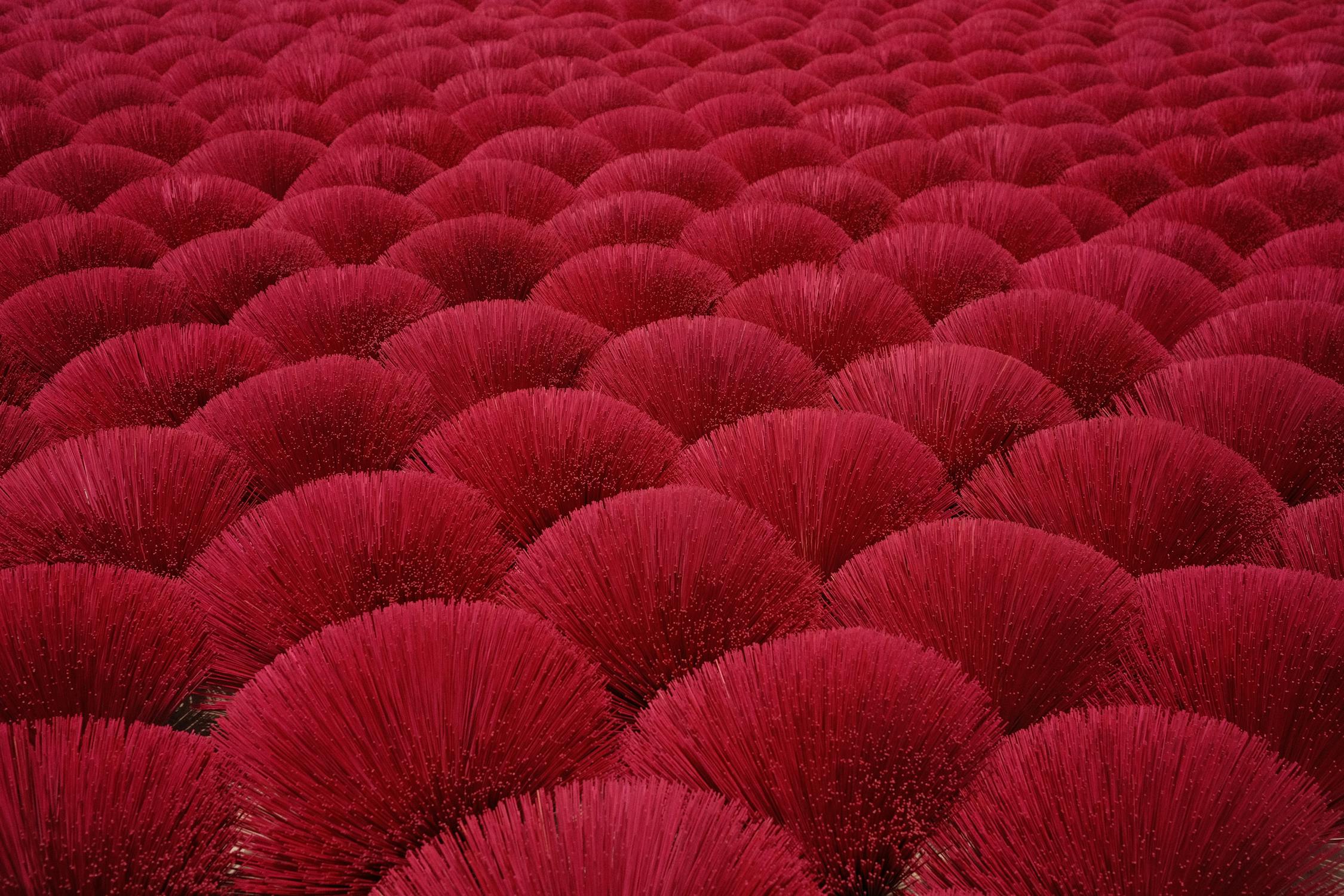 A large pile of red bamboo sticks · Free Stock Photo