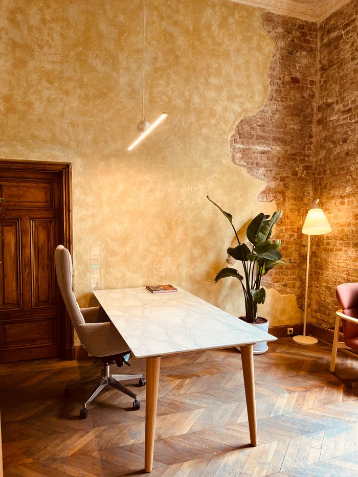Warm interior with a wooden desk and soft lighting — photo by Cinnamon A. on Pexels