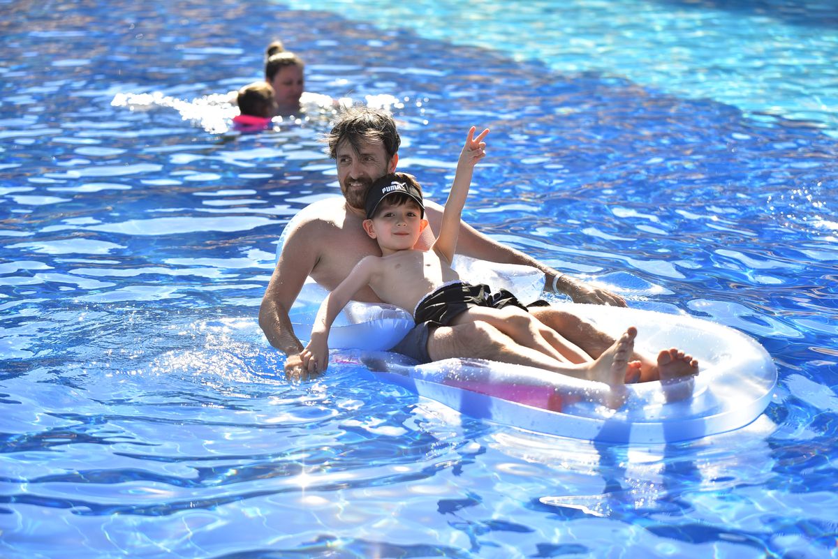 Personas disfrutando de un baño en una piscina exterior