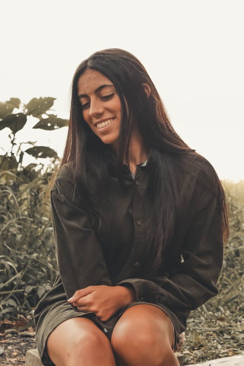 Woman Smiling Near Bushes