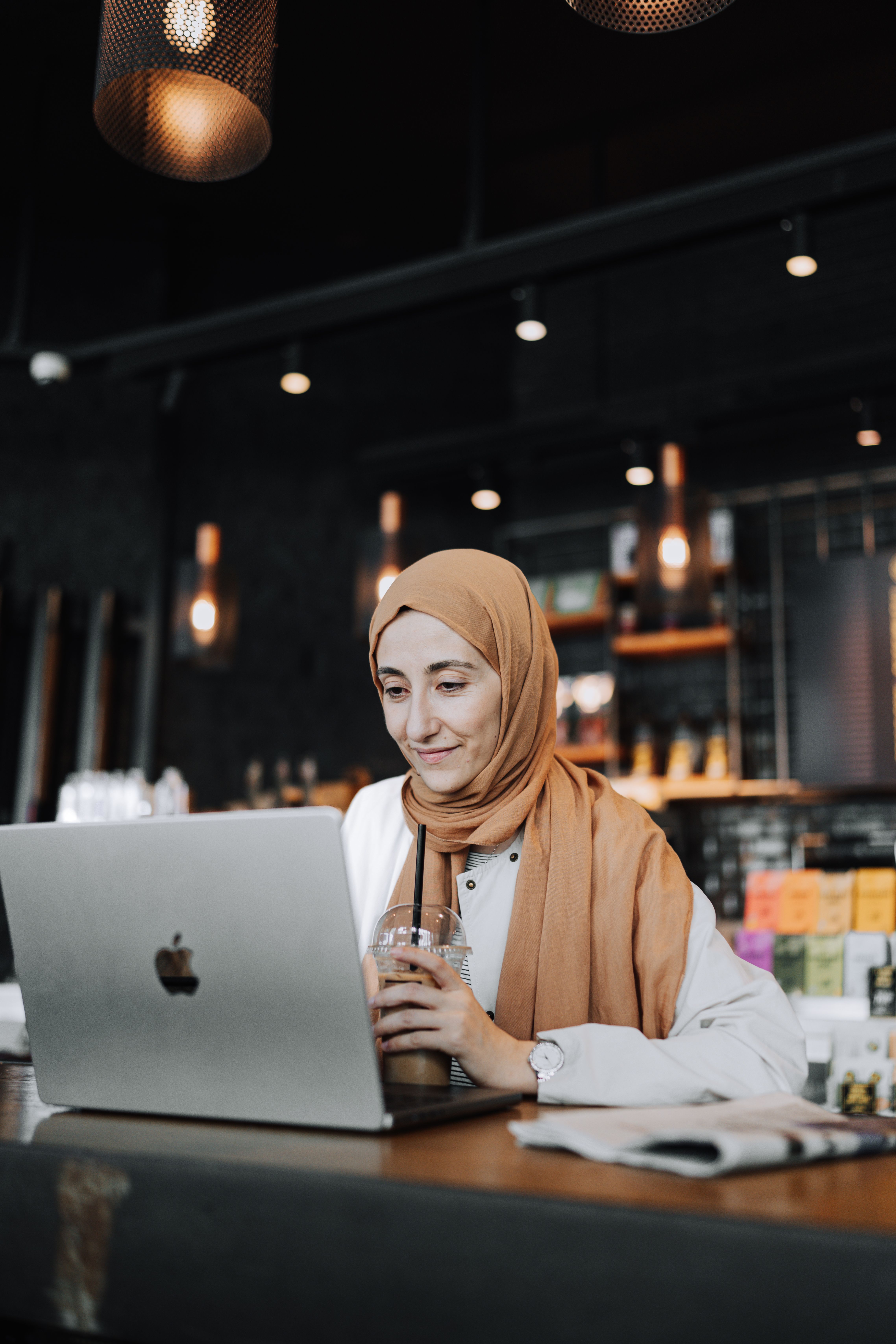 Pilgrim using a laptop to customise a dynamic multi city Umrah and holiday itinerary