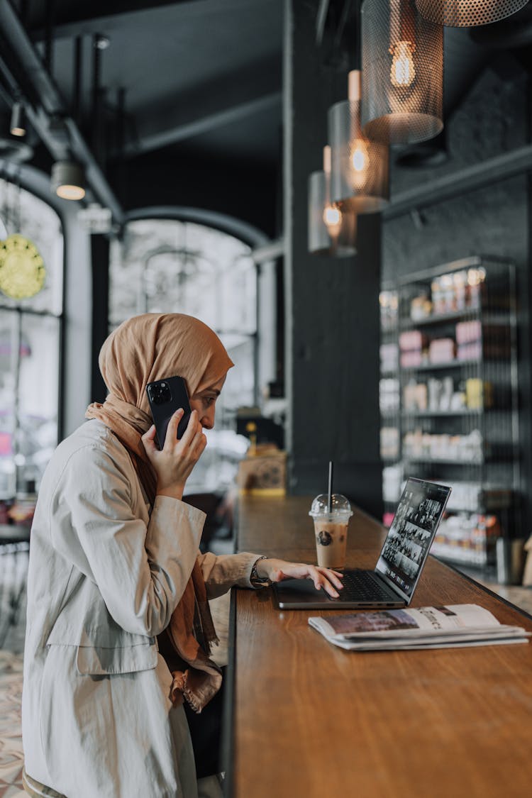 Woman Multitasking At Cafe