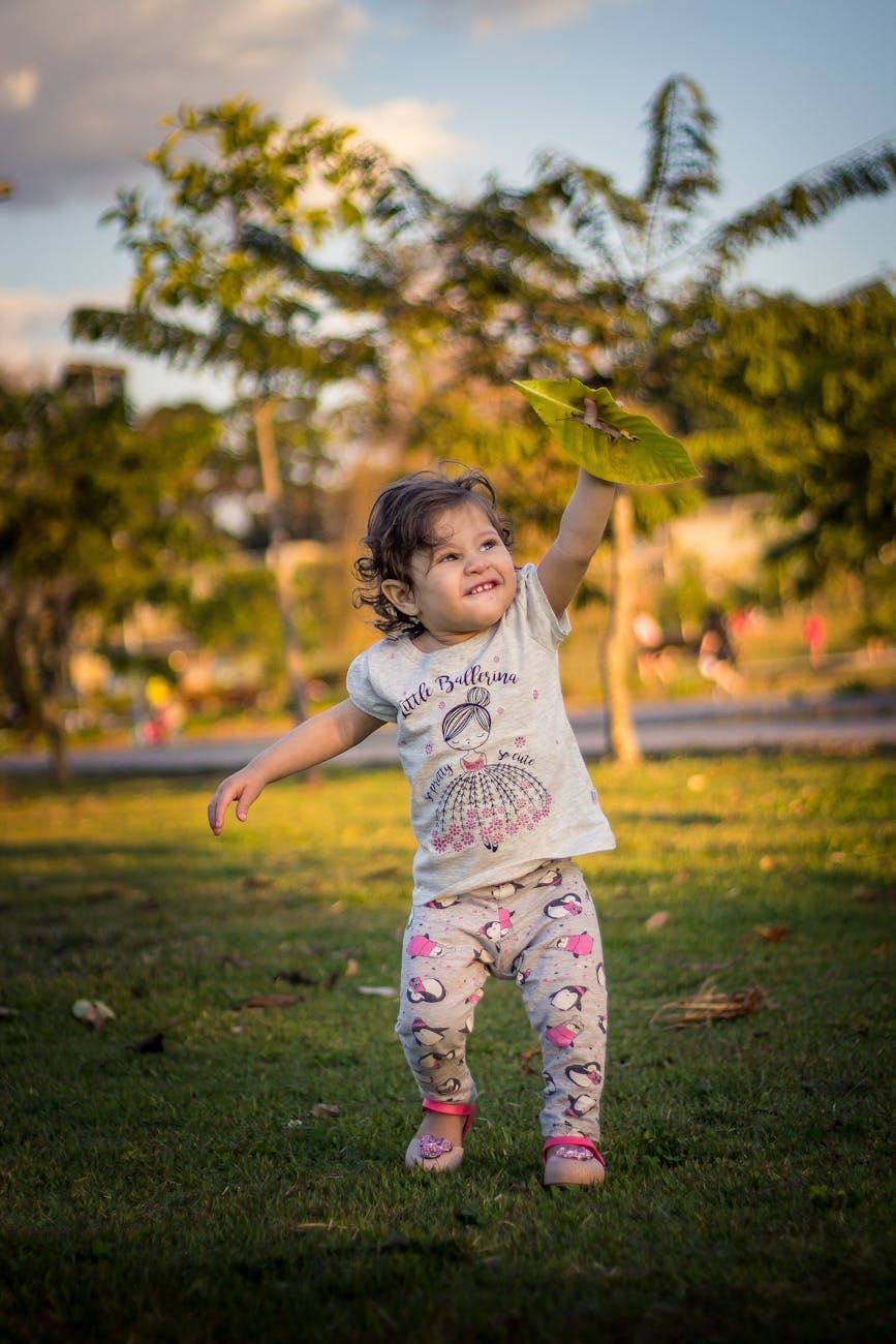 girl holding green leaf