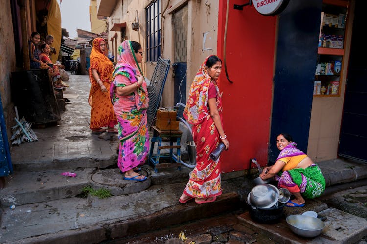 Women In Sari Waiting In Line To Public Street Tap