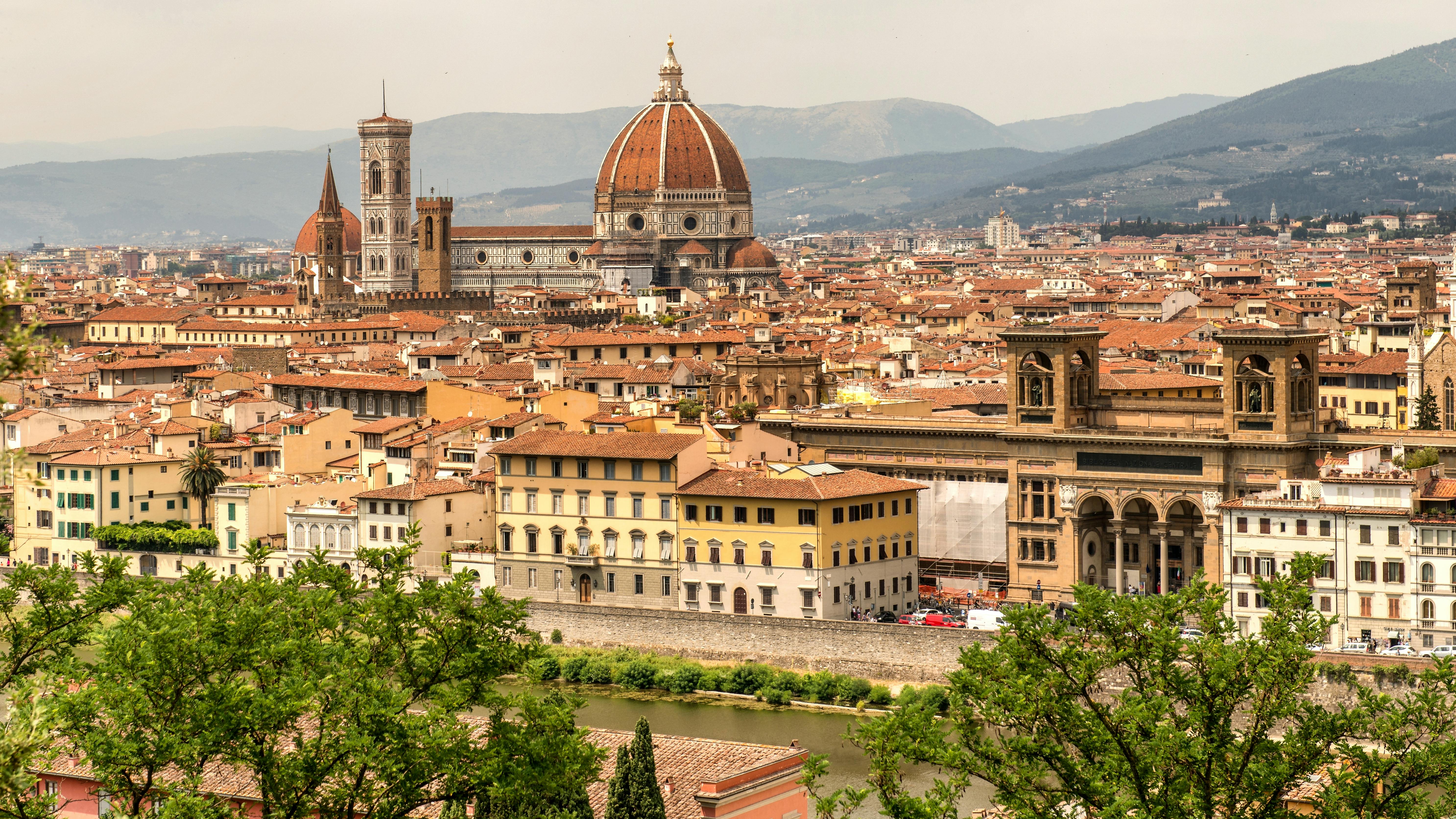 Stunning aerial view of Florence showcasing the iconic Duomo and historic cityscape during the day.