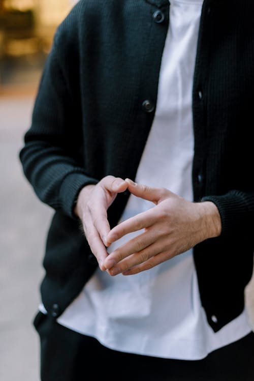 Pyramid Hands of Person in Black Jacket