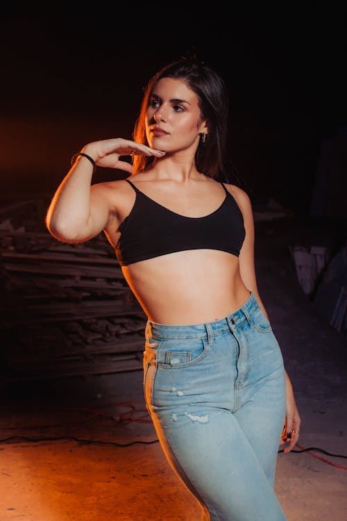 Young Woman Posing in Jeans and a Short Black Top 