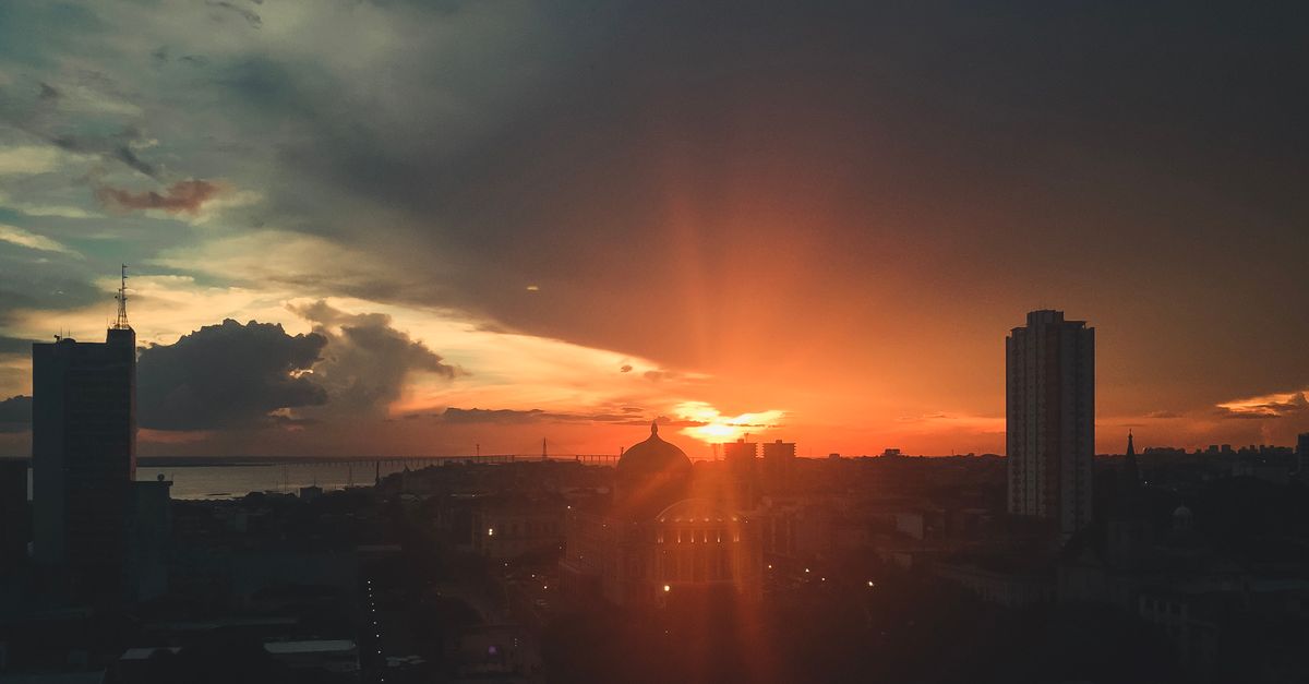 Sunset over Ho cityscape with Christ Embassy Loveworld Arena in the distance