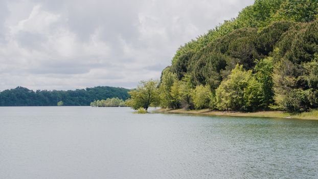 A lake with trees and water in the background