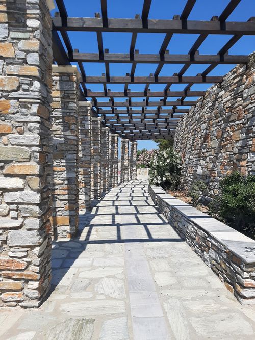 Free Stone colonnade with shadows and blue sky in Greece, showcasing modern architectural elements. Stock Photo