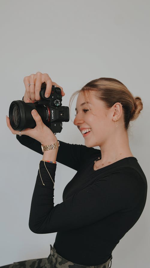 Smiling Young Woman with Camera