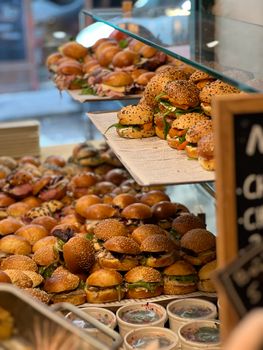 A tempting display of assorted fresh sandwiches and buns in a bakery.