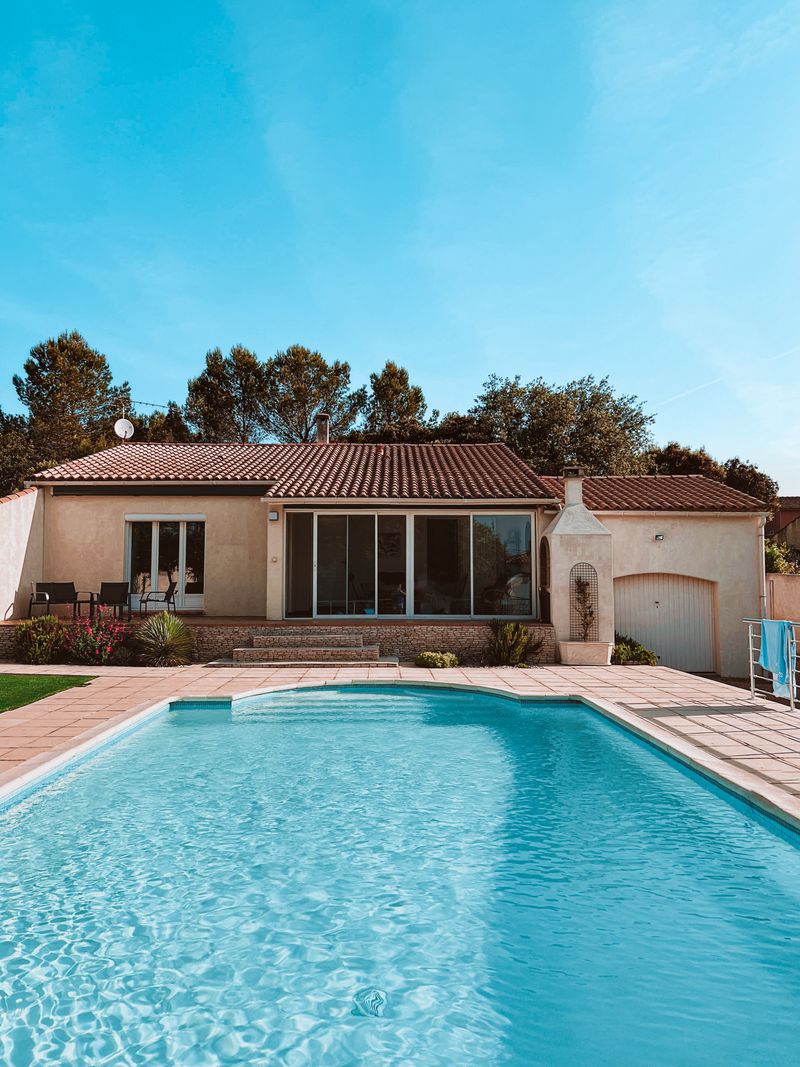 Swimming pool beside a house — photo by Vincent Rivaud on Pexels